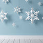 Snowflake Paper Cutting Hanging Before Blue Wall Backdrop Shopbackdrop