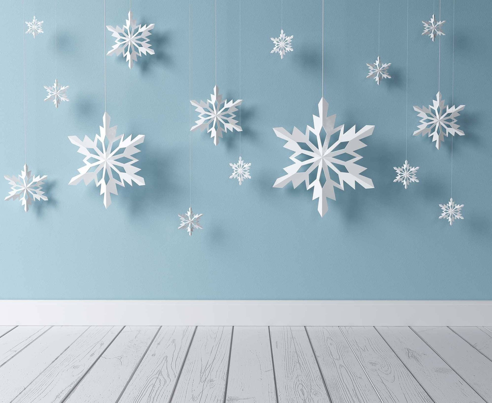 Snowflake Paper Cutting Hanging Before Blue Wall Backdrop Shopbackdrop